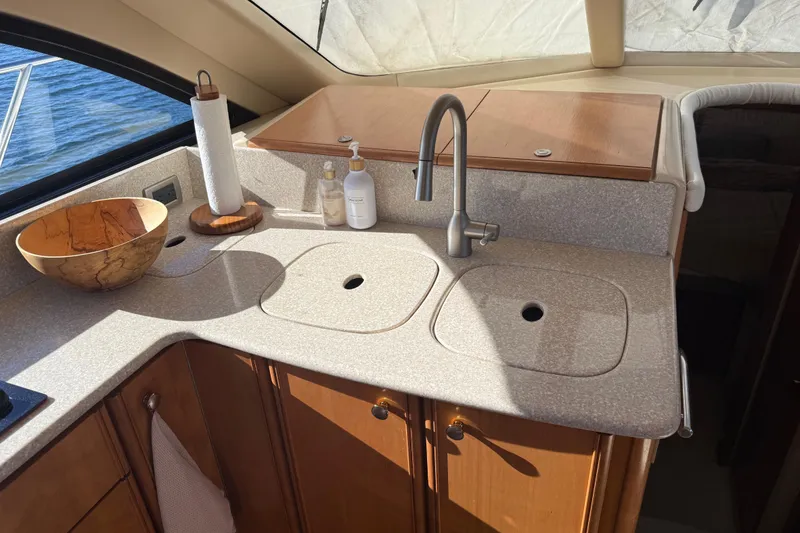 Slide: The Image of Luxurious 2004 Meridian 411 Sedan yacht kitchen with modern sink and wooden cabinetry. - 37