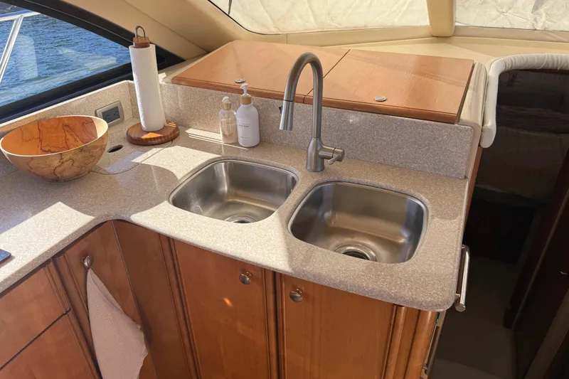 Slide: The Image of Luxurious kitchen area in a 2004 Meridian 411 Sedan yacht with dual sinks. - 38
