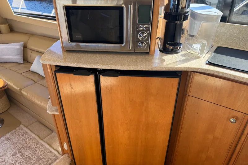 Slide: The Image of Kitchen area in a 2004 Meridian 411 Sedan yacht with microwave and coffee maker. - 39