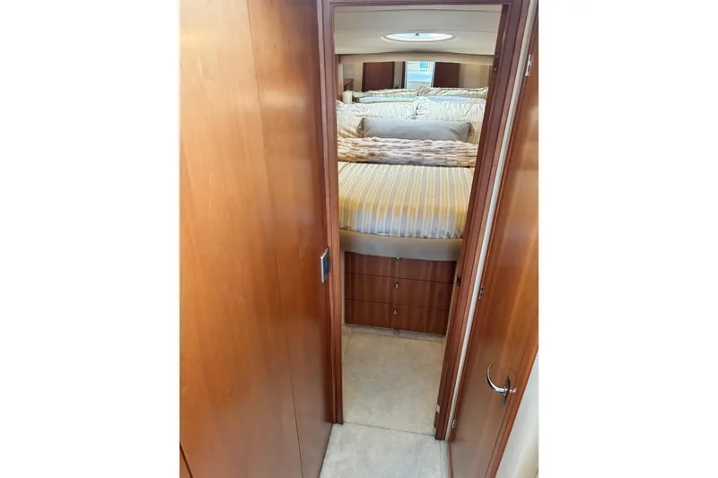 Slide: The Image of Interior cabin view of 2004 Meridian 411 Sedan yacht with cozy bed and wooden finish. - 42