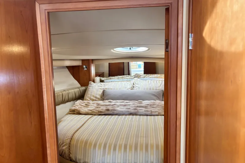 Slide: The Image of Luxurious bedroom interior of 2004 Meridian 411 Sedan yacht with striped bedding. - 43