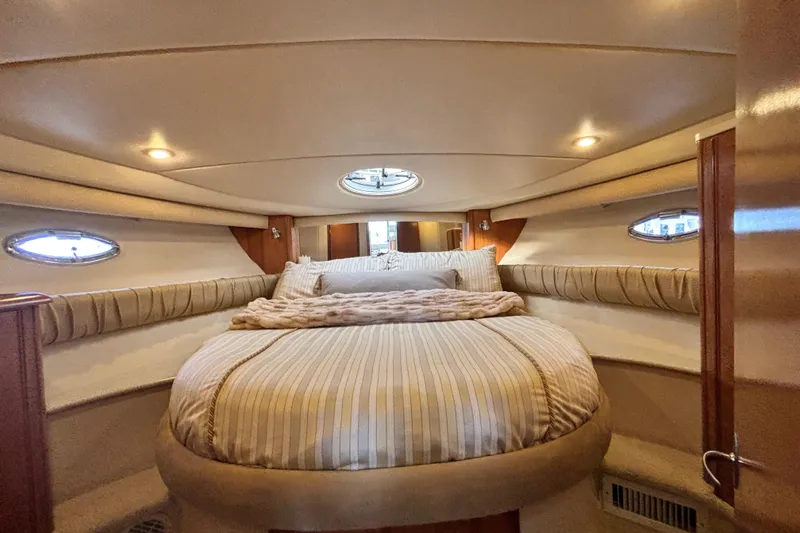 Slide: The Image of Luxurious interior of 2004 Meridian 411 Sedan yacht with cozy bed and elegant lighting. - 44