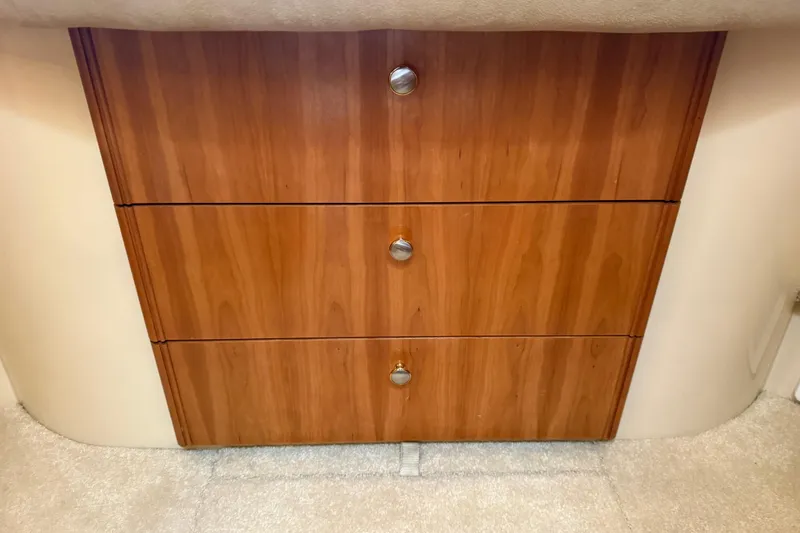 Slide: The Image of Wooden drawers in a 2004 Meridian 411 Sedan interior, featuring sleek metal handles. - 46