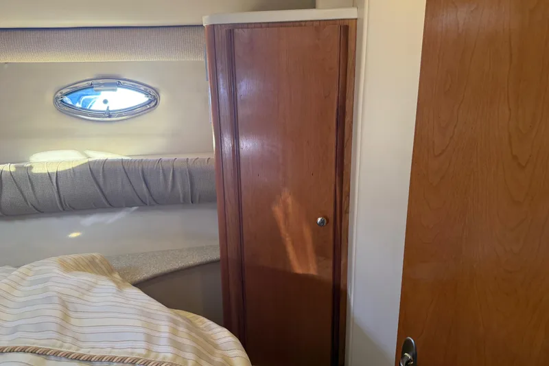 Slide: The Image of Interior of a 2004 Meridian 411 Sedan yacht with wooden cabinetry and porthole window. - 47