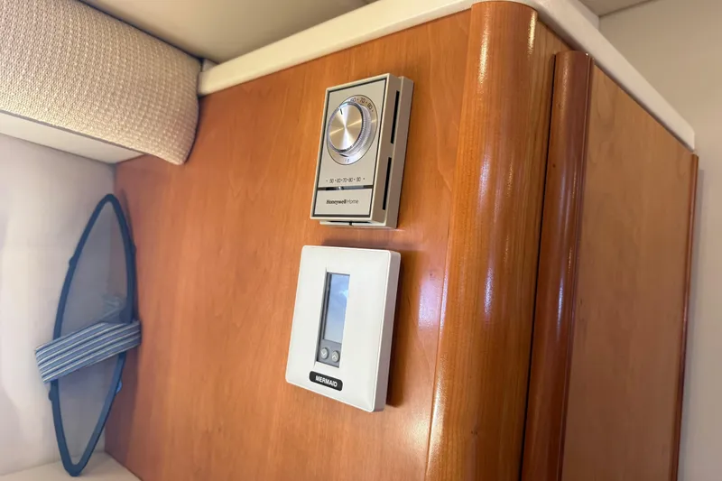 Slide: The Image of 2004 Meridian 411 Sedan interior with Honeywell and Mermaid control panels. - 49