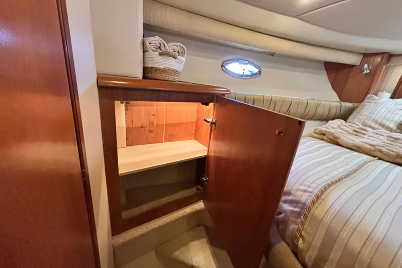 Slide: The Image of 2004 Meridian 411 Sedan interior with open wooden cabinet and cozy bed. - 52