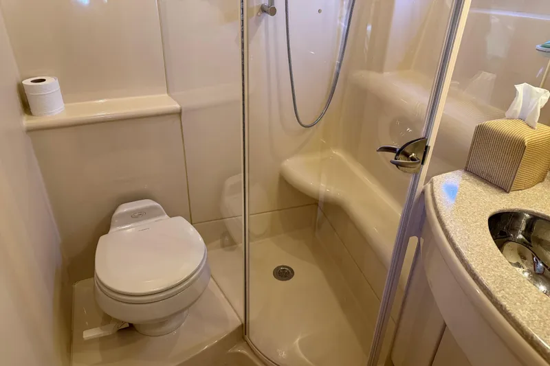 Slide: The Image of Compact bathroom in 2004 Meridian 411 Sedan yacht with shower, toilet, and sink. - 56