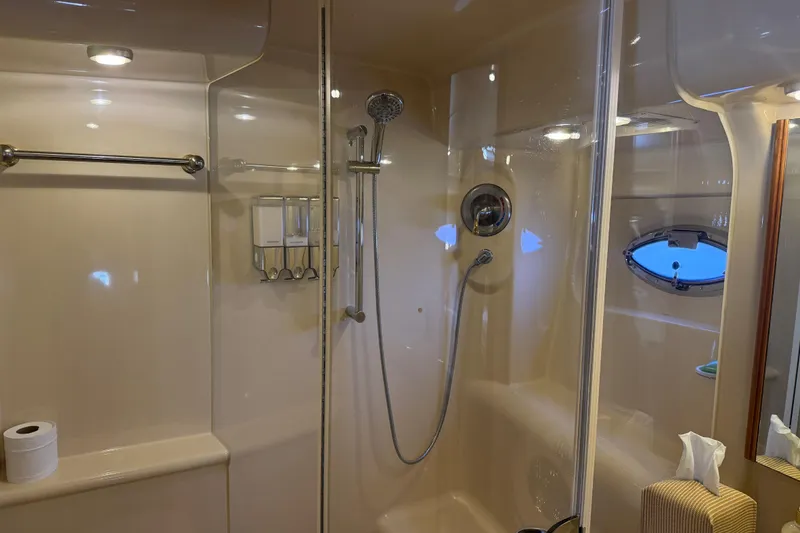 Slide: The Image of Luxurious bathroom in 2004 Meridian 411 Sedan yacht with shower and porthole window. - 57