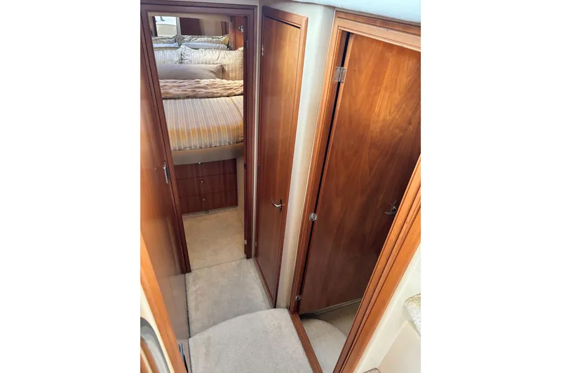 Slide: The Image of 2004 Meridian 411 Sedan interior hallway with wooden doors and cozy bedroom. - 58