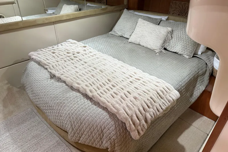 Slide: The Image of Luxurious bedroom interior in a 2004 Meridian 411 Sedan yacht, featuring elegant bedding. - 62