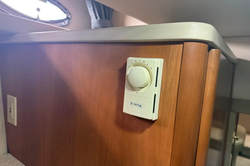 Slide: The Image of Thermostat on wooden panel inside 2004 Meridian 411 Sedan boat interior. - 65