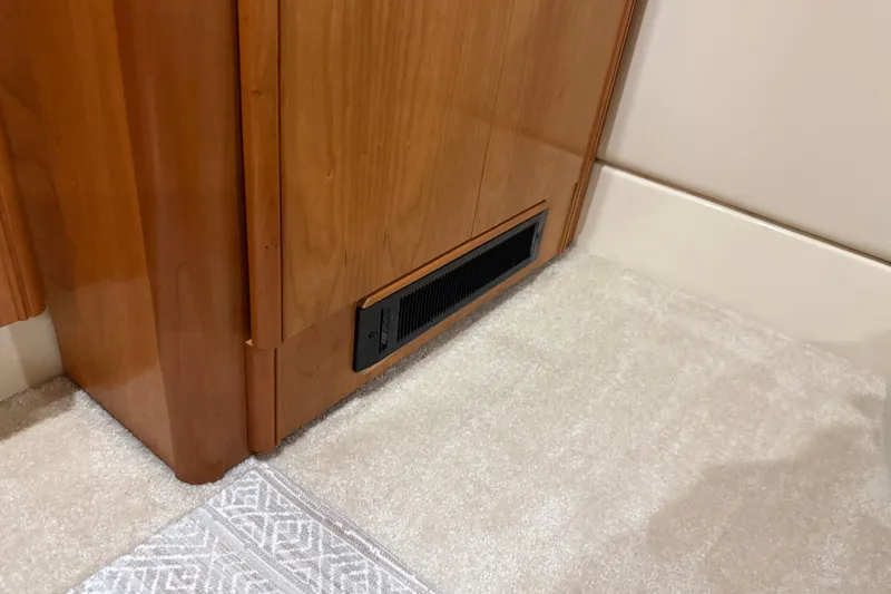 Slide: The Image of Wooden cabinet with vent on carpeted floor, Meridian 411 Sedan 2004 interior. - 66