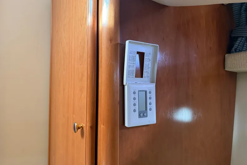 Slide: The Image of Thermostat on wooden panel inside 2004 Meridian 411 Sedan yacht interior. - 68