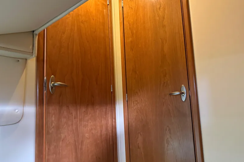 Slide: The Image of Wooden interior doors with metal handles on a 2004 Meridian 411 Sedan yacht. - 71