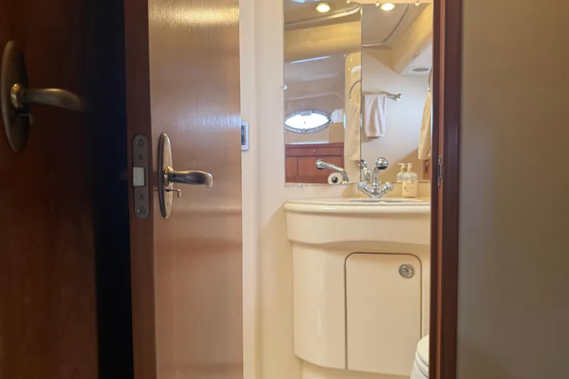 Slide: The Image of Bathroom interior of 2004 Meridian 411 Sedan yacht, featuring sink and mirror. - 72