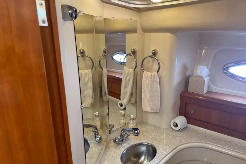 Slide: The Image of Luxurious bathroom in 2004 Meridian 411 Sedan yacht with mirror, sink, and towel. - 74