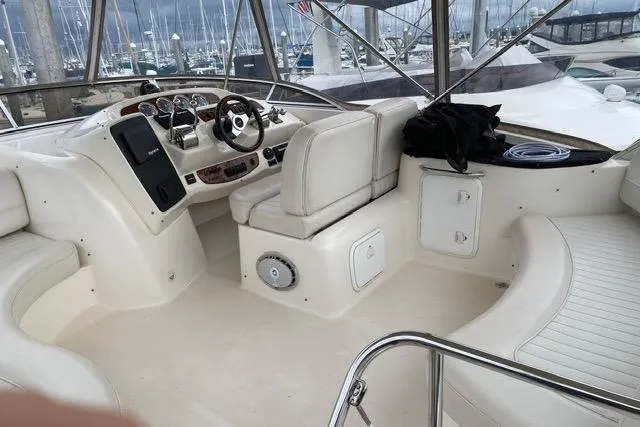 Slide: The Image of Interior of a 2004 Meridian 411 Sedan yacht with white seating and control panel. - 77