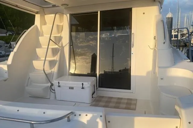 Slide: The Image of 2004 Meridian 411 Sedan yacht deck with stairs and sliding glass door. - 8