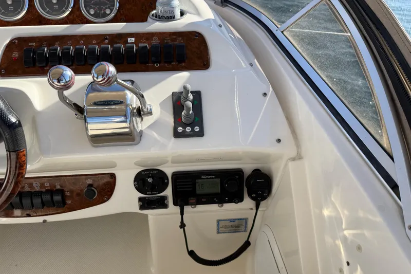 Slide: The Image of 2004 Meridian 411 Sedan helm with throttle controls and navigation instruments. - 82