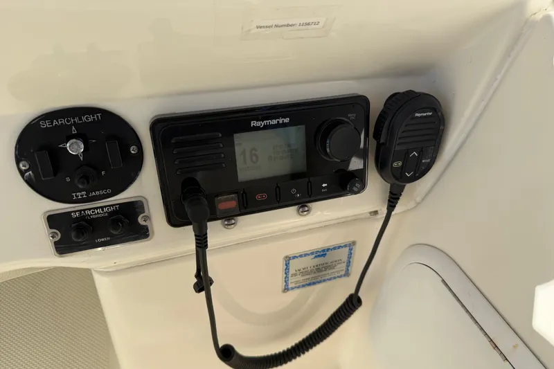 Slide: The Image of Control panel of a 2004 Meridian 411 Sedan with Raymarine radio and searchlight controls. - 83