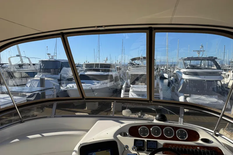 Slide: The Image of View from 2004 Meridian 411 Sedan yacht helm, overlooking marina with multiple boats docked. - 85
