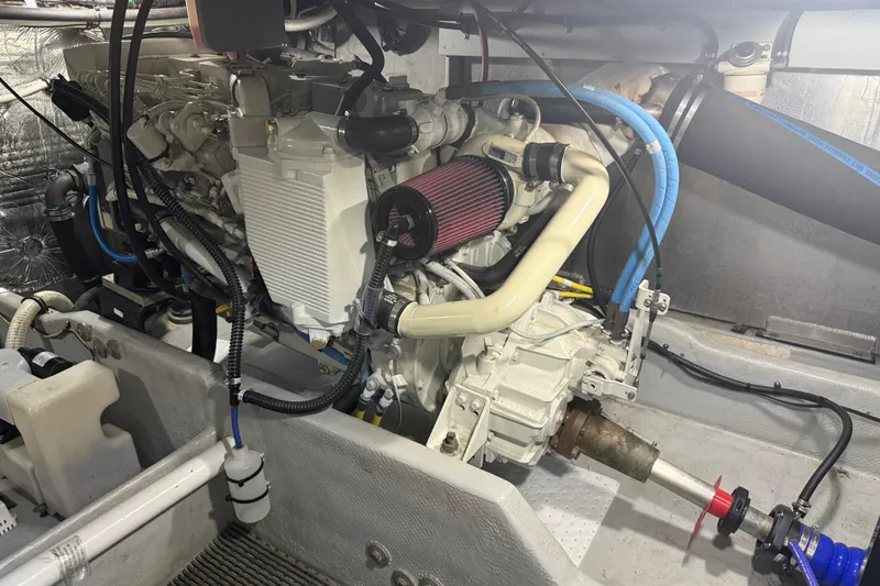 Slide: The Image of Engine compartment of a 2004 Meridian 411 Sedan boat, showcasing mechanical components and wiring. - 91