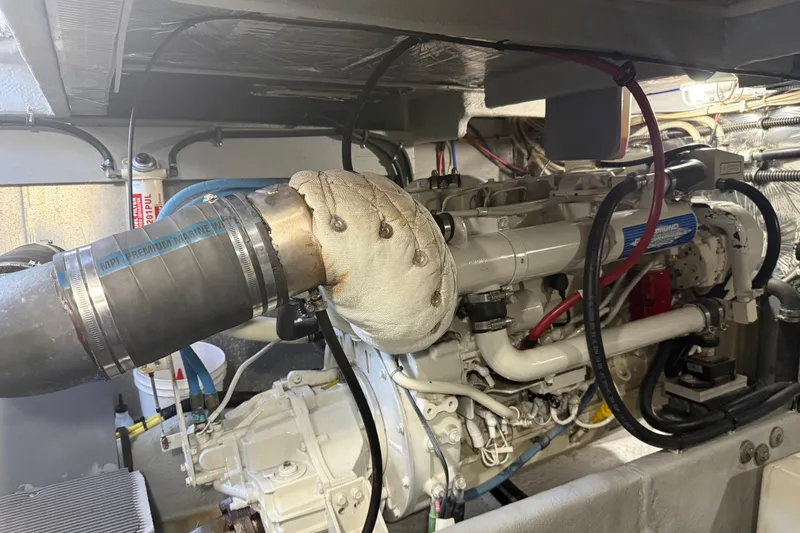 Slide: The Image of Engine room of a 2004 Meridian 411 Sedan with visible marine engine components. - 92