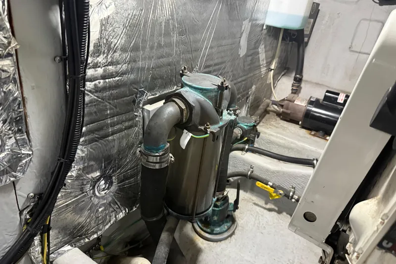 Slide: The Image of Engine room of 2004 Meridian 411 Sedan with visible piping and insulation. - 95