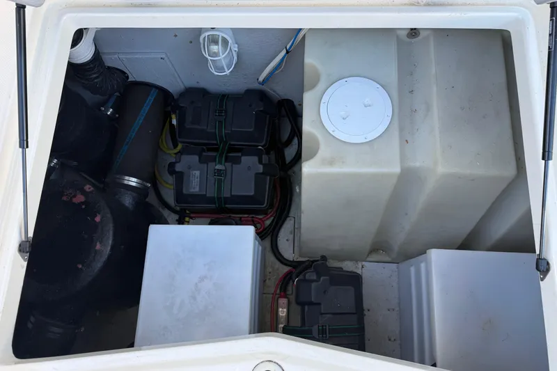 Slide: The Image of Engine compartment of a 2004 Meridian 411 Sedan, showing batteries and wiring. - 98