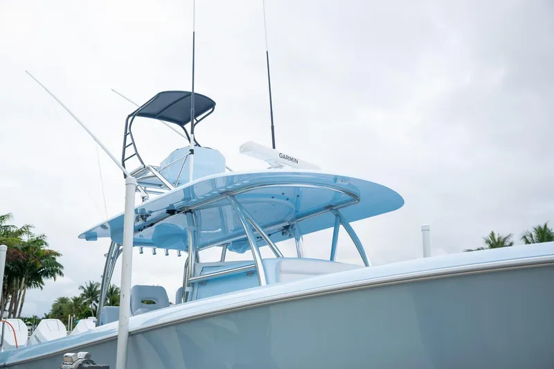 Slide: The Image of 2026 Contender 44 ST boat with blue canopy and Garmin equipment. - 11