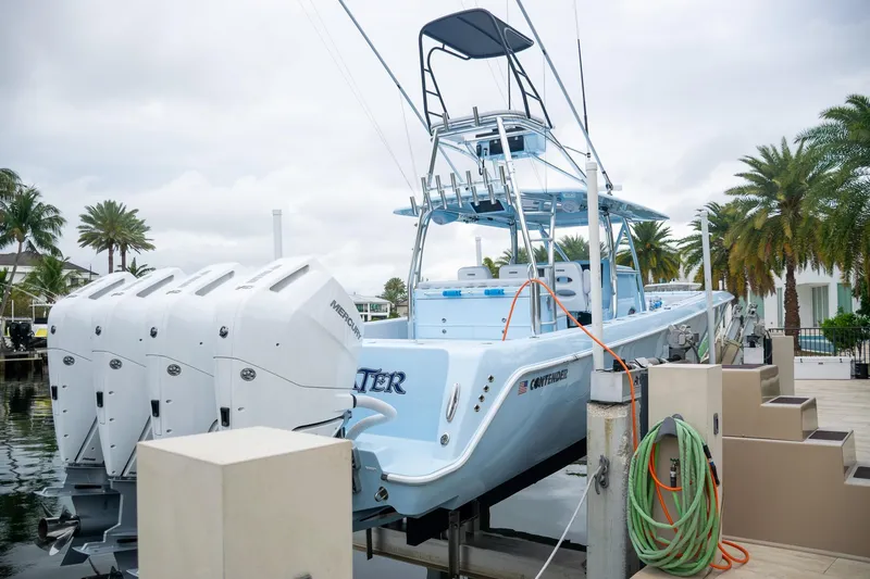 Slide: The Image of Contender 44 ST 2026 boat with four outboard engines at the dock. - 12