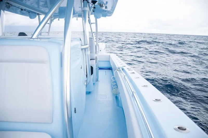 Slide: The Image of 2026 Contender 44 ST boat on open ocean, showcasing sleek design and spacious deck. - 24