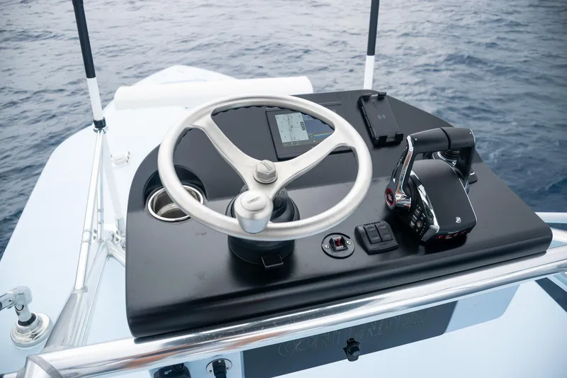 Slide: The Image of Steering console of 2026 Contender 44 ST boat on open water. - 32