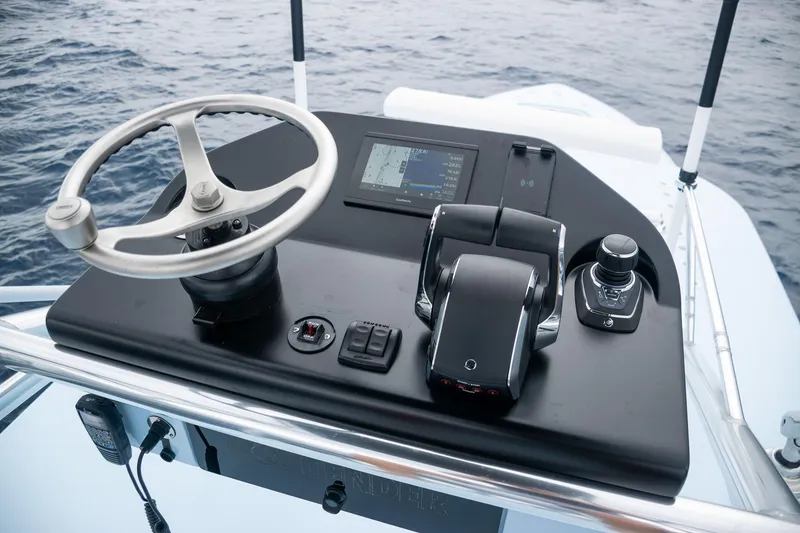 Slide: The Image of Contender 44 ST 2026 helm console on open sea. - 33