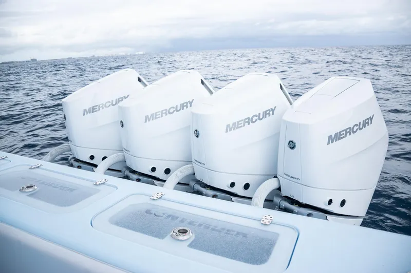 Slide: The Image of Four Mercury outboard engines on a 2026 Contender 44 ST boat in open water. - 56