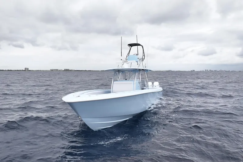 Slide: The Image of 2026 Contender 44 ST boat on open ocean under cloudy sky. - 7