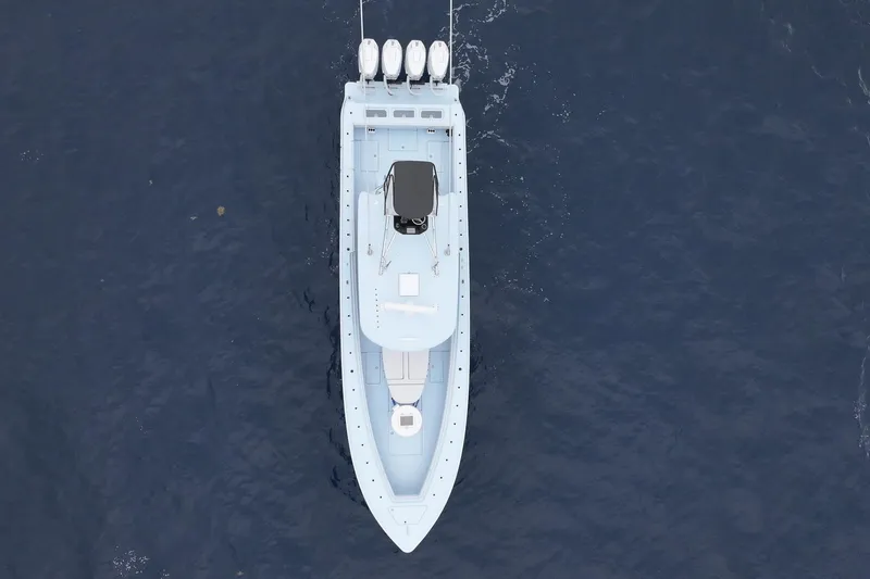 Slide: The Image of 2026 Contender 44 ST boat navigating on open ocean under cloudy skies. - 8