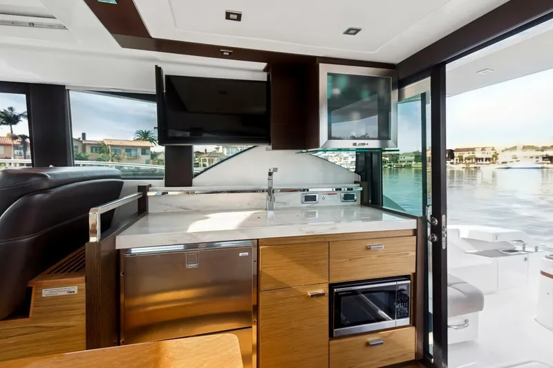 Slide: The Image of Interior of 2017 Tiara Yachts C39 Coupe with modern kitchen and waterfront view. - 14