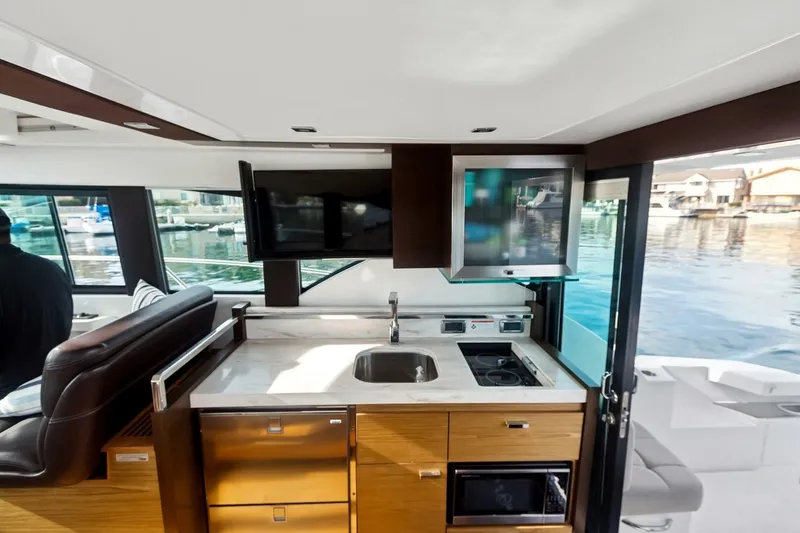 Slide: The Image of Interior of 2017 Tiara Yachts C39 Coupe, featuring modern kitchen and waterfront view. - 16