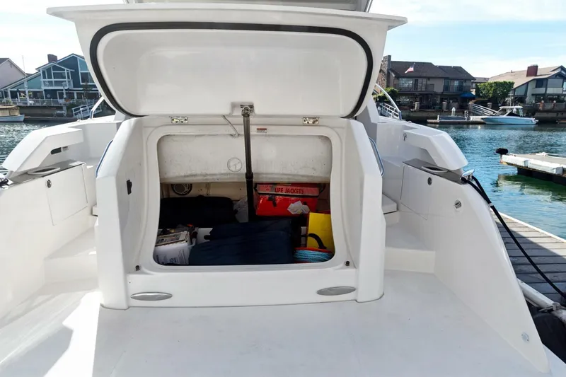 Slide: The Image of 2017 Tiara Yachts C39 Coupe storage compartment with life jackets and equipment, dockside view. - 25