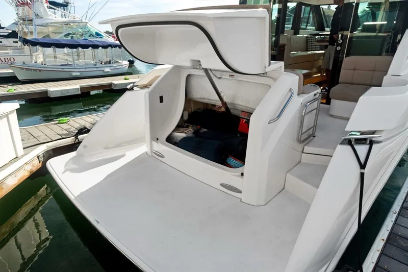 Slide: The Image of 2017 Tiara Yachts C39 Coupe with open storage compartment at marina dock. - 26
