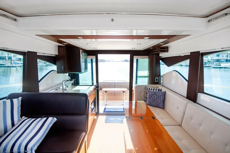 Slide: The Image of Interior of 2017 Tiara Yachts C39 Coupe, featuring elegant seating and waterfront views. - 3