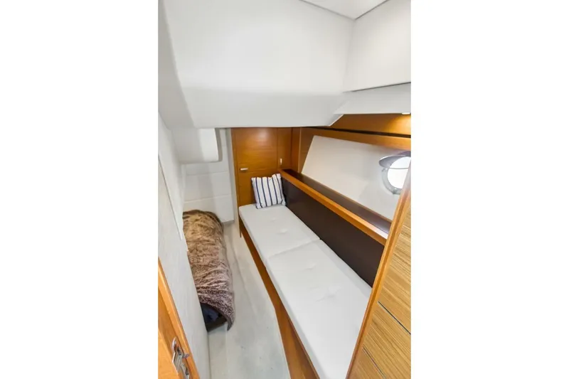 Slide: The Image of 2017 Tiara Yachts C39 Coupe cabin interior with cozy bedding and modern design. - 6