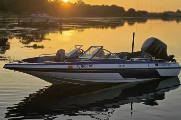 The Image of 2017 Skeeter SL 190 boat on calm water at sunset. - 0