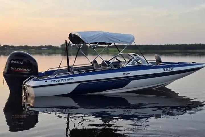 Slide: The Image of 2017 Skeeter SL 190 boat with Yamaha engine on calm water at sunset. - 10
