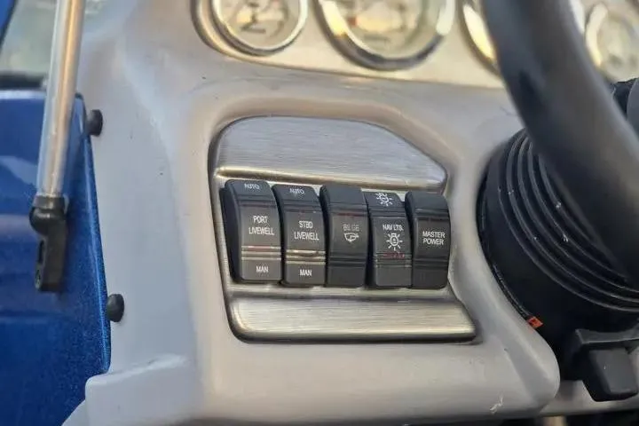 Slide: The Image of Control panel of a 2017 Skeeter SL 190 boat with various switches. - 12