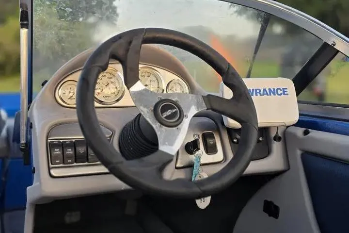 Slide: The Image of Steering wheel and dashboard of a 2017 Skeeter SL 190 boat. - 13