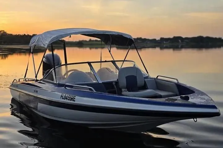 Slide: The Image of 2017 Skeeter SL 190 boat on calm lake at sunset with canopy. - 17