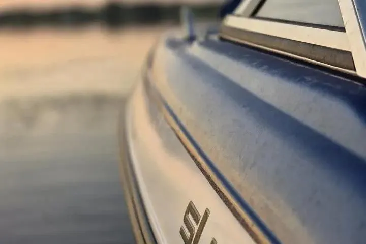 Slide: The Image of Close-up of 2017 Skeeter SL 190 boat side, with blurred water background. - 19