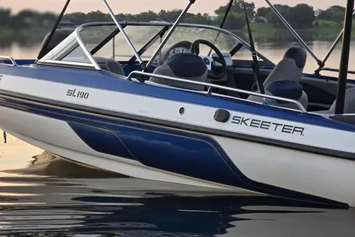 Slide: The Image of 2017 Skeeter SL 190 boat on calm water, showcasing sleek design and blue accents. - 20